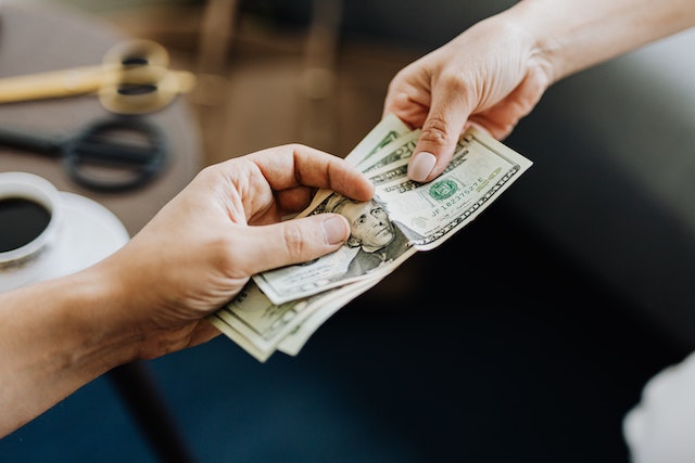 two people exchanging money